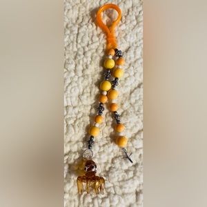 Handmade Glass octopus with metal cross keychain.